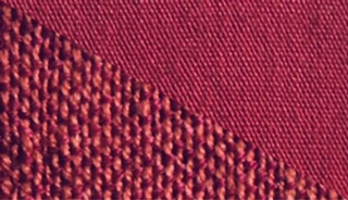 Fabric swatch dyed in light burgundy red, demonstrating the vibrant color achieved with our dye on different fabrics